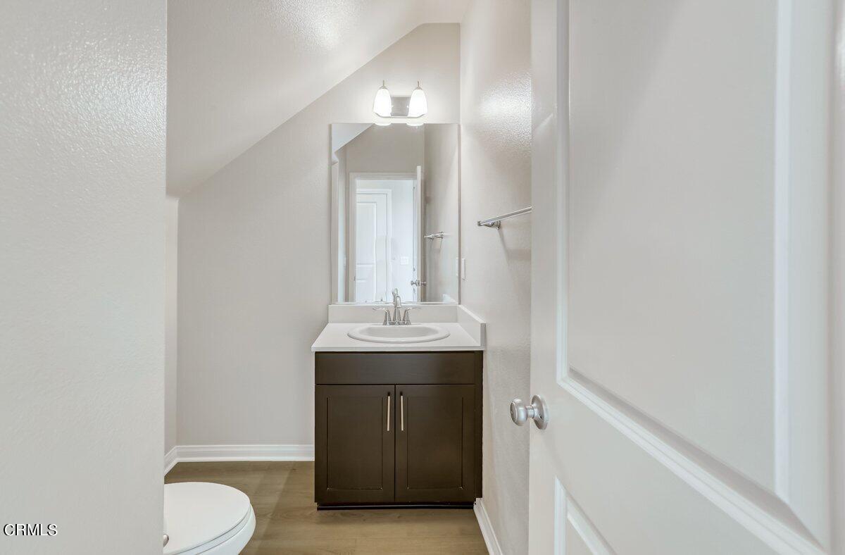 225 Stonegate Road Camarillo, CA 93010 - Photo 13 of 32 a bathroom with a sink and mirror with toilet