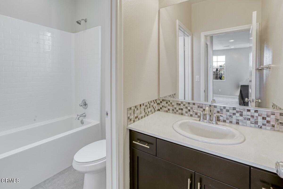 225 Stonegate Road Camarillo, CA 93010 - Photo 20 of 32 a bathroom with a sink a toilet a mirror a bathtub and shower