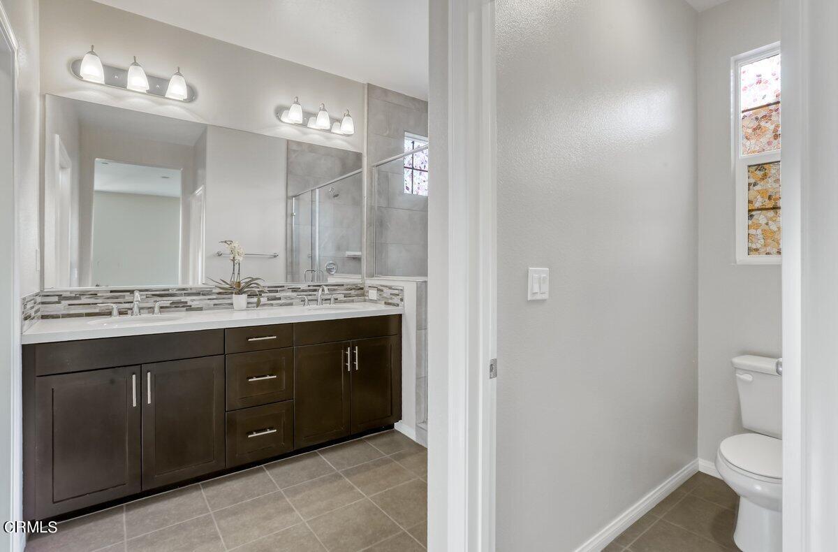 225 Stonegate Road Camarillo, CA 93010 - Photo 26 of 32 a spacious bathroom with a double vanity sink a toilet and a mirror