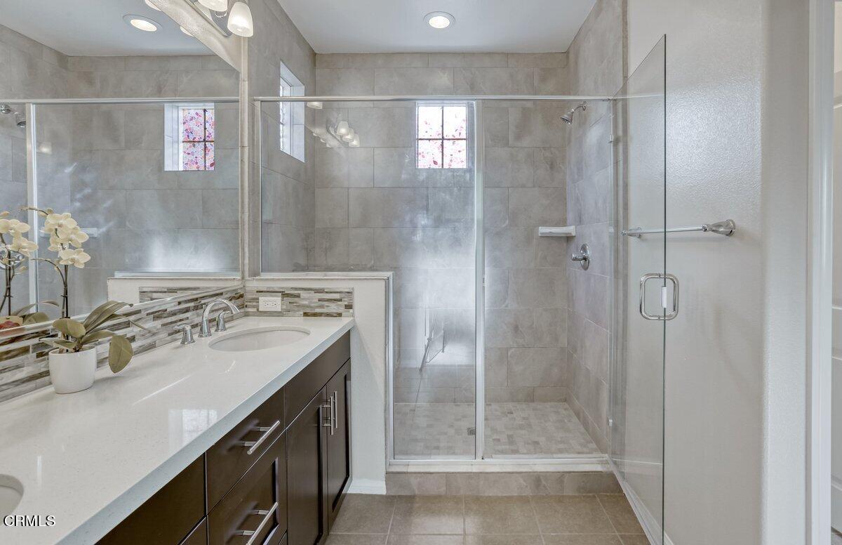 225 Stonegate Road Camarillo, CA 93010 - Photo 27 of 32 a bathroom with a shower sink vanity and mirror
