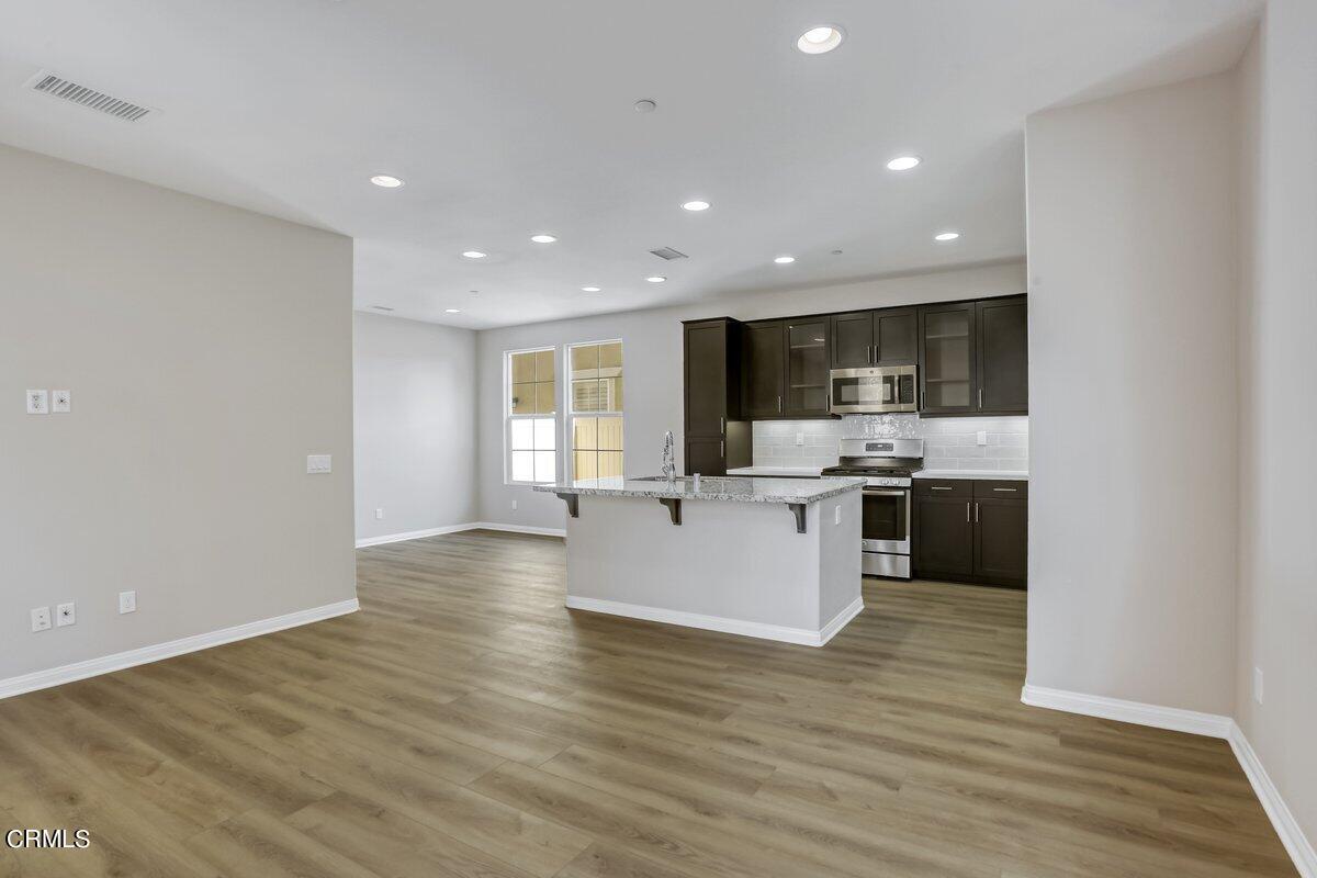 225 Stonegate Road Camarillo, CA 93010 - Photo 7 of 32 a view of kitchen with kitchen island a sink wooden floor and stainless steel appliances