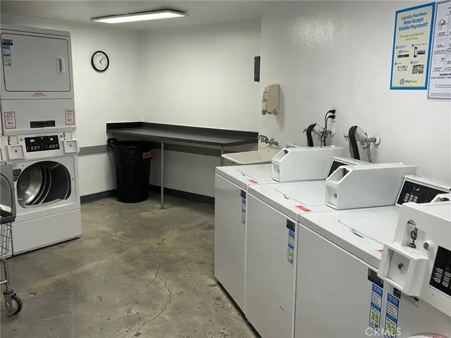 a utility room with dryer washer and sink