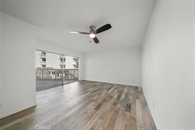 a view of a room with wooden floor and white walls