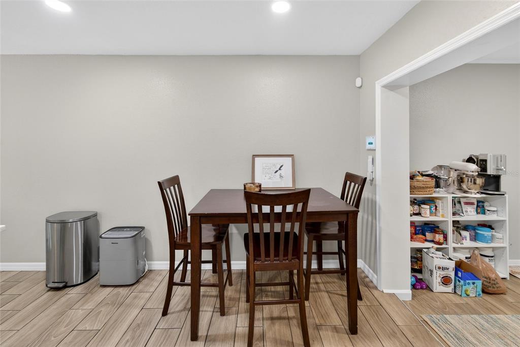 5502 Peach Avenue Seffner, FL 33584 - Photo 22 of 48 a view of a dining room with furniture and wooden floor