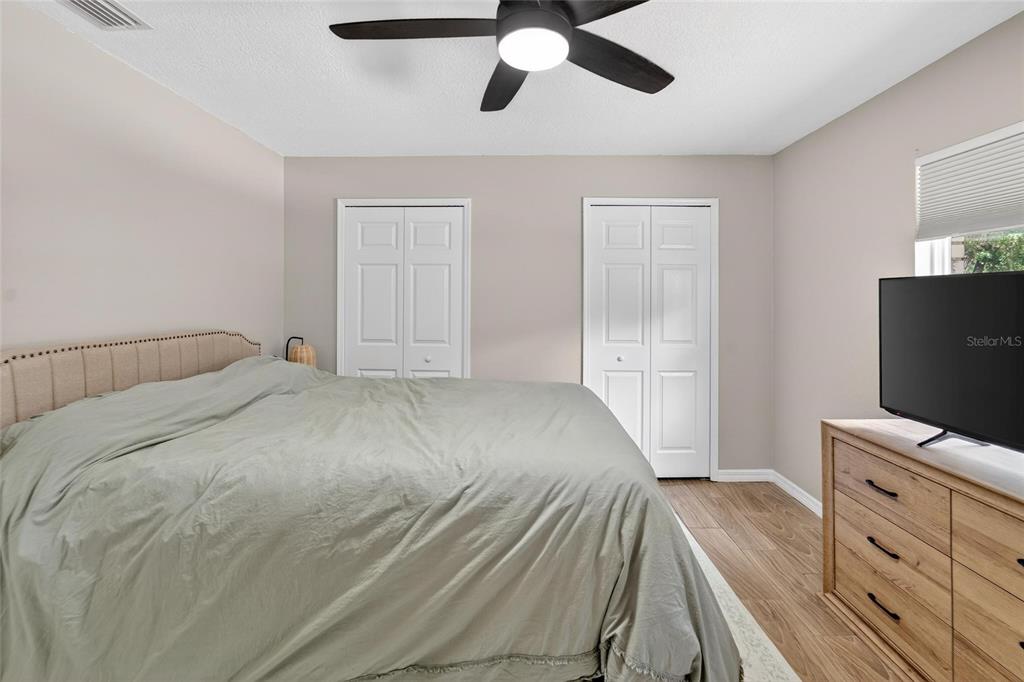 5502 Peach Avenue Seffner, FL 33584 - Photo 27 of 48 a bedroom with a bed and wooden floor