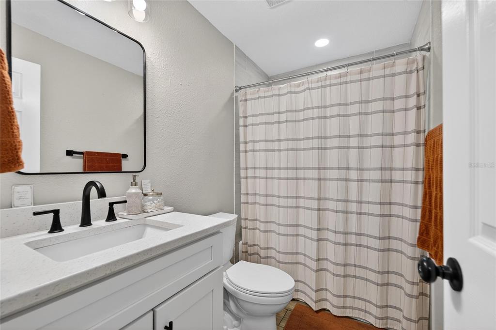 5502 Peach Avenue Seffner, FL 33584 - Photo 32 of 48 a bathroom with a sink a toilet and shower curtain