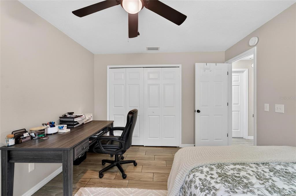 5502 Peach Avenue Seffner, FL 33584 - Photo 38 of 48 a bedroom with a bed and a table