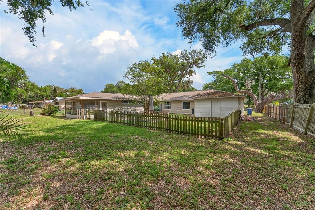 5502 Peach Avenue Seffner, FL 33584 - Photo 42 of 48 a view of a house with a yard and a garden