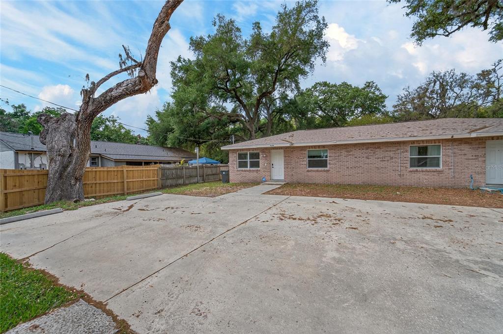 5502 Peach Avenue Seffner, FL 33584 - Photo 8 of 48 a view of a house with a backyard and a tree