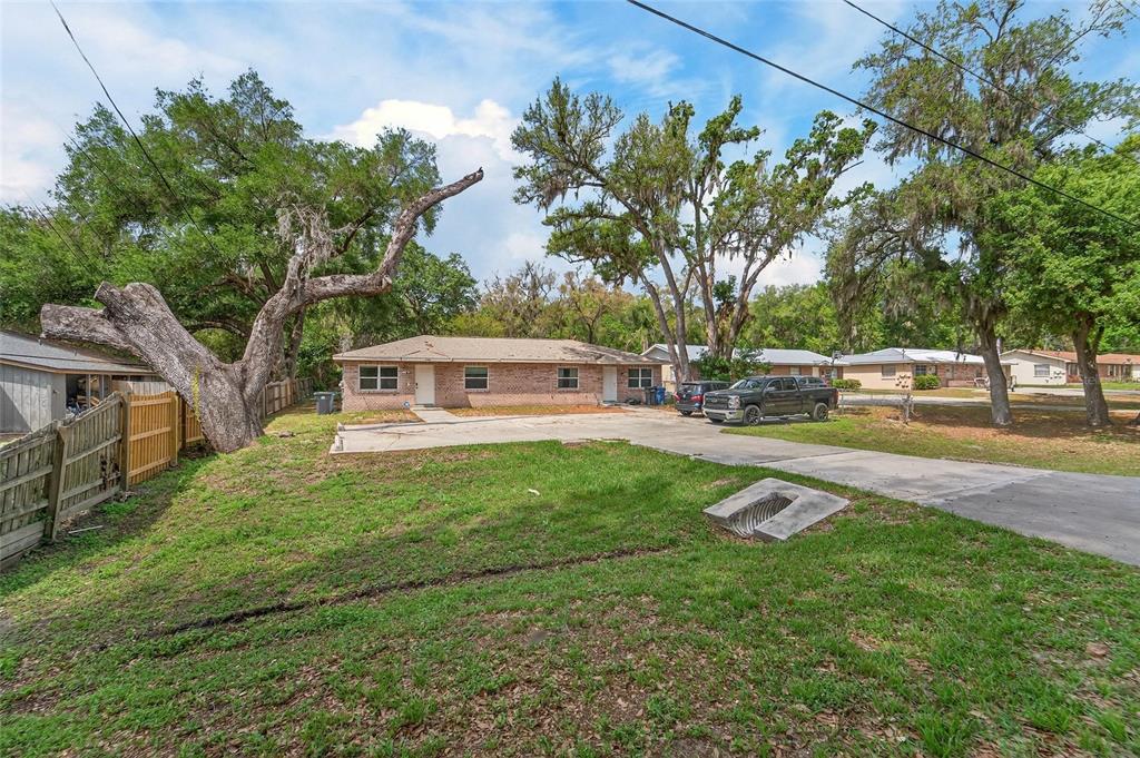 5502 Peach Avenue Seffner, FL 33584 - Photo 10 of 48 a view of a yard with plants and trees