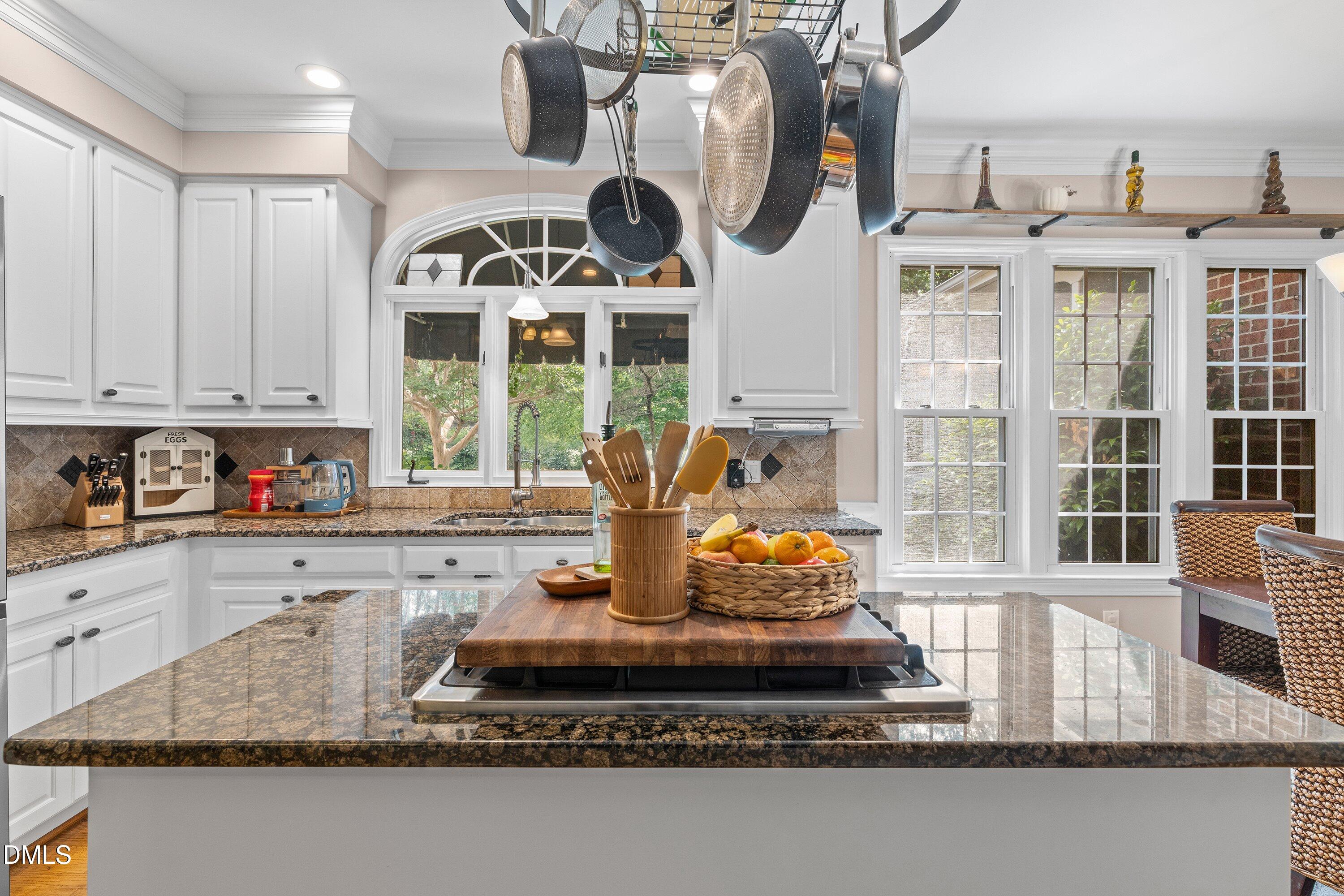 6612 Fowler Road Zebulon, NC 27597 - Photo 11 of 42 a kitchen with a stove a sink and a granite counter tops