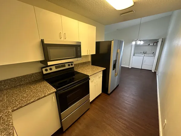 a kitchen with a stove and a microwave