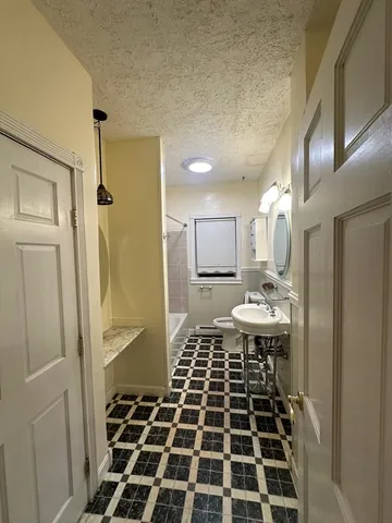 a view of a bathroom with a sink and a mirror