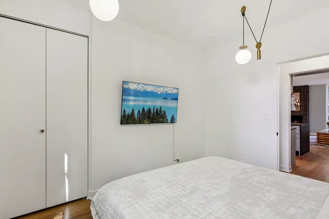 a view of a room with wooden floor and fan