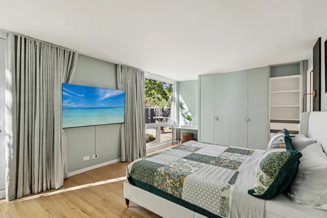 a bedroom with a large bed and a window