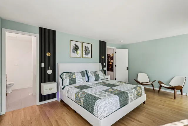 a bedroom with a bed and chair