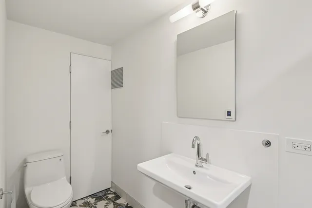 a bathroom with a sink toilet and vanity