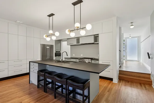 a kitchen with counter space and wooden floor