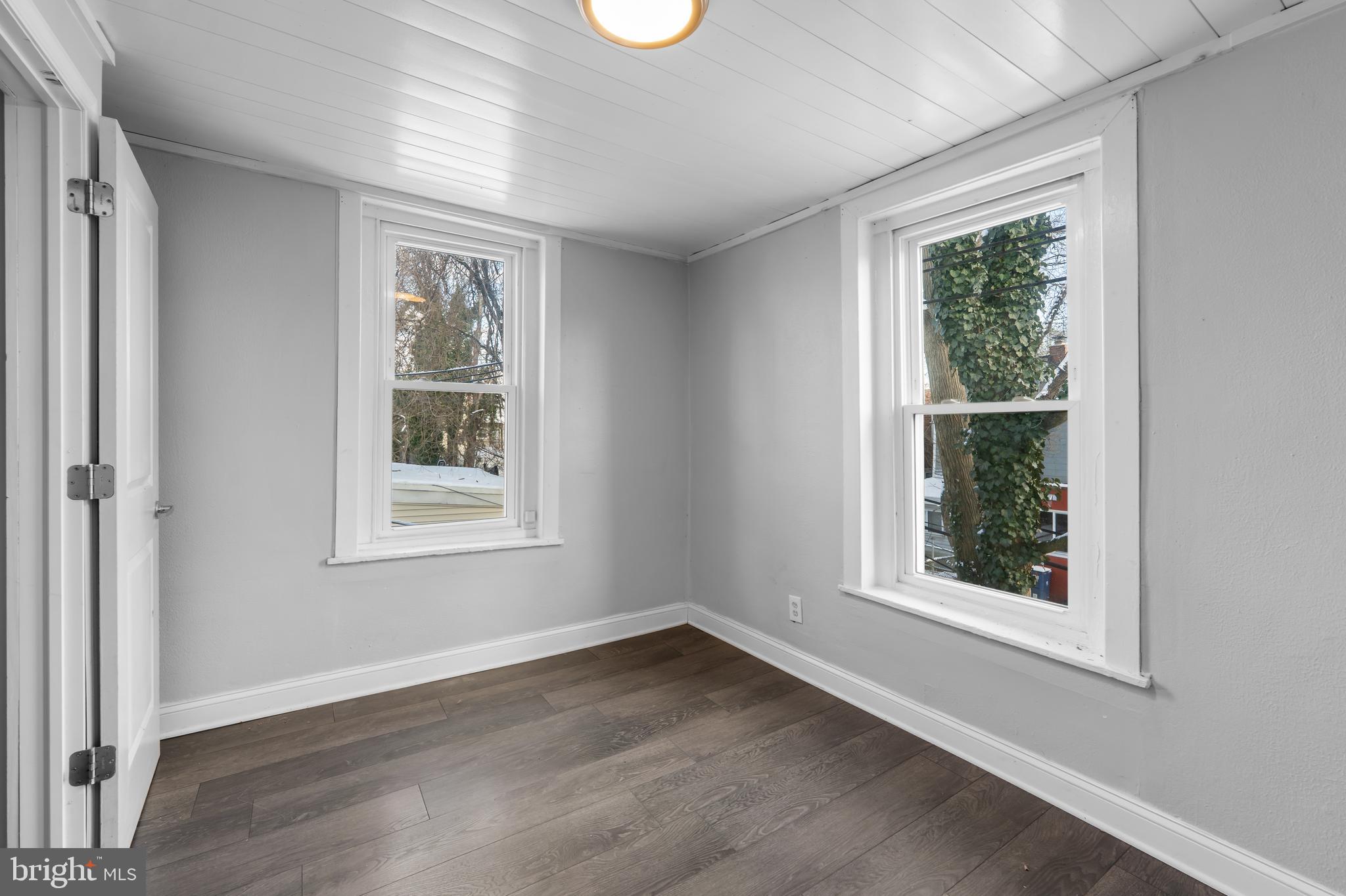 118 East Springer Street Philadelphia, PA 19119 - Photo 17 of 22 an empty room with wooden floor and windows