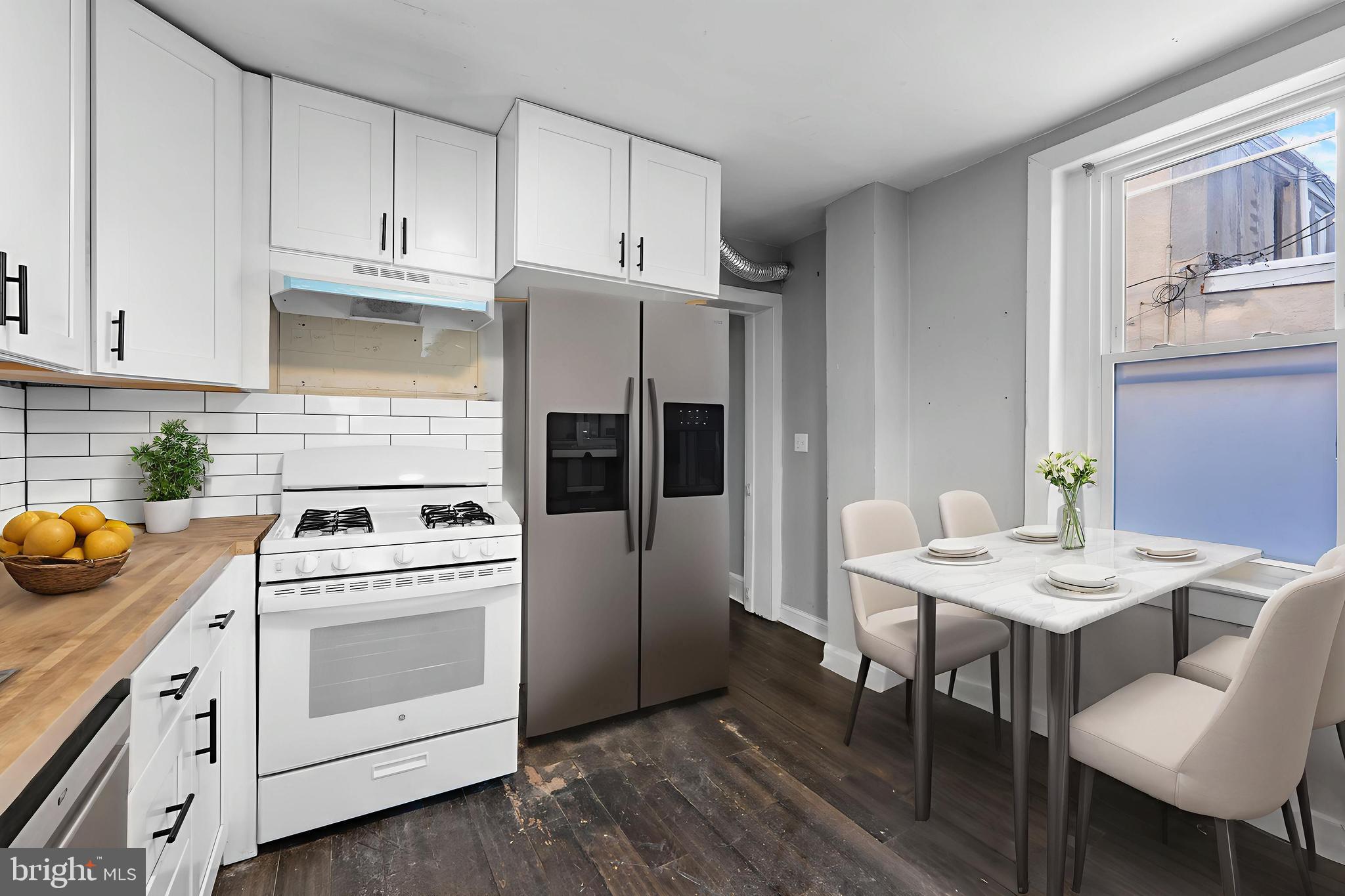 118 East Springer Street Philadelphia, PA 19119 - Photo 4 of 22 a kitchen with a white stove top oven and white cabinets