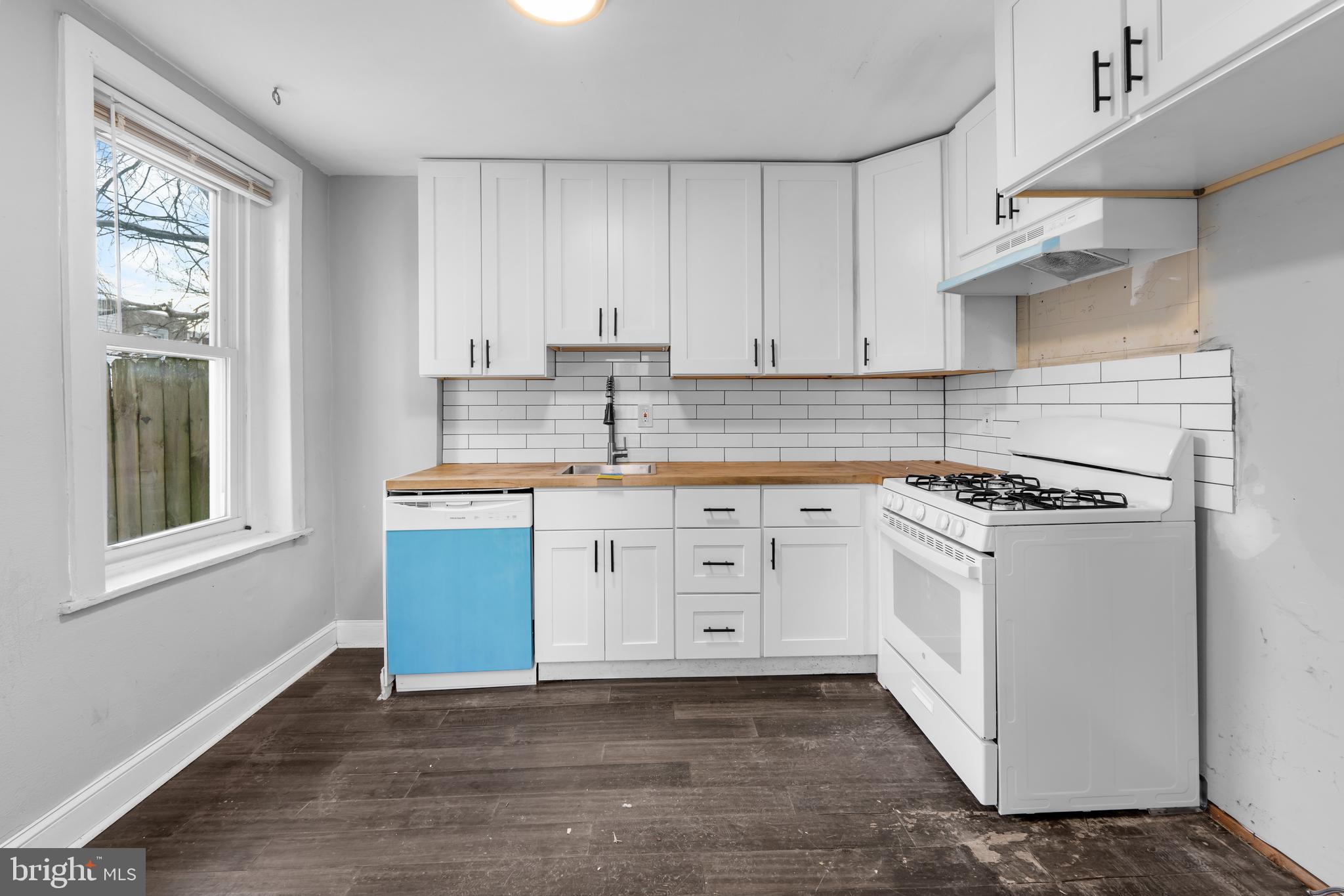 118 East Springer Street Philadelphia, PA 19119 - Photo 8 of 22 a kitchen with granite countertop white cabinets and white appliances