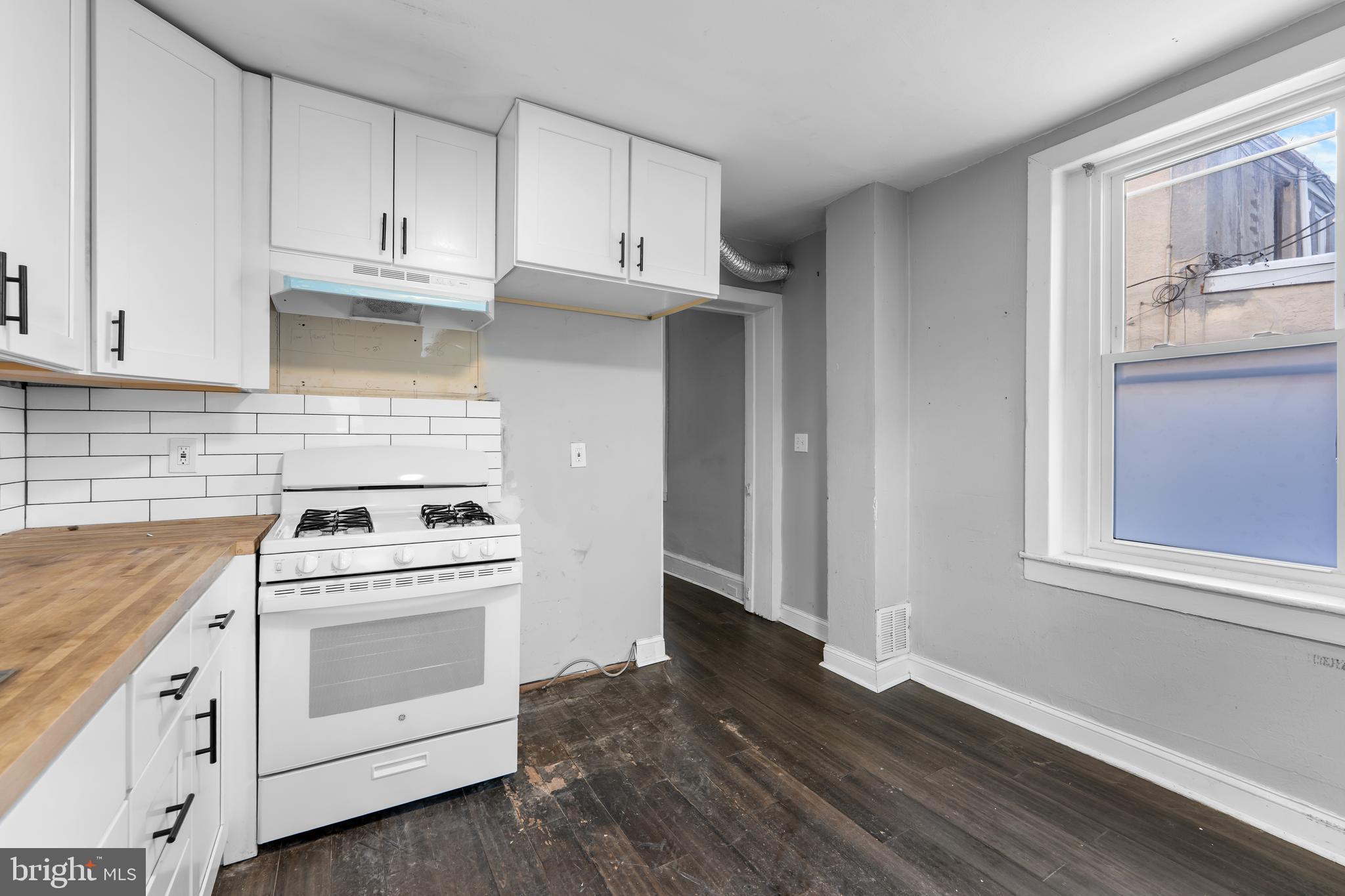 118 East Springer Street Philadelphia, PA 19119 - Photo 9 of 22 a kitchen with white cabinets and white appliances
