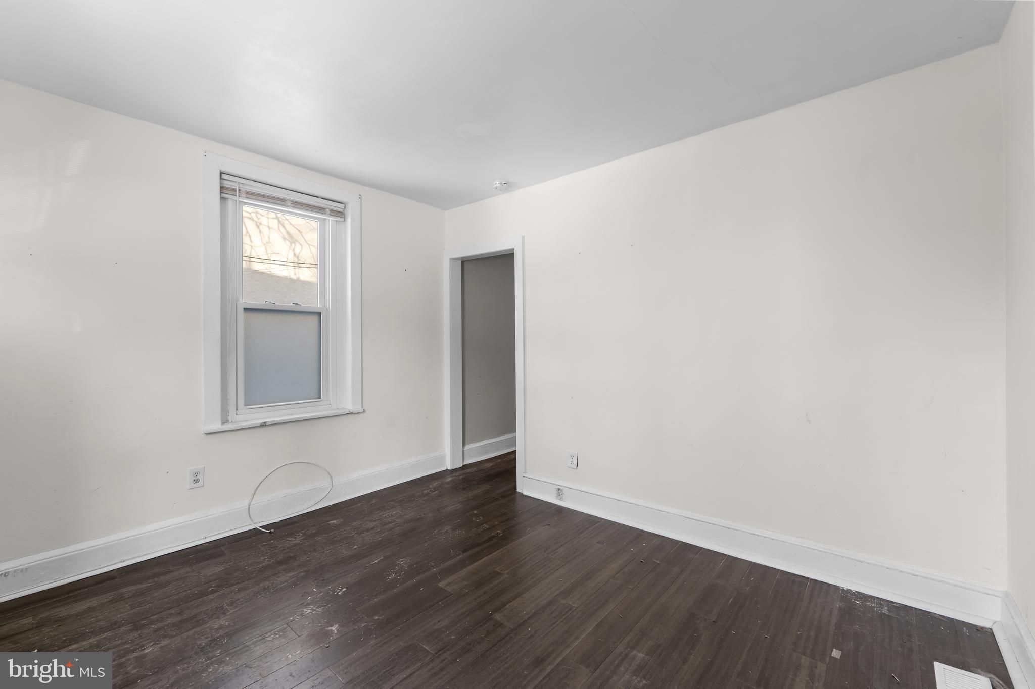 118 East Springer Street Philadelphia, PA 19119 - Photo 10 of 22 an empty room with wooden floor and windows