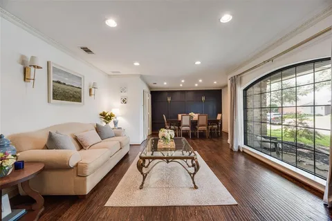 a living room with furniture rug and wooden floor