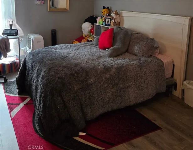 a bed sitting in a bedroom next to a window