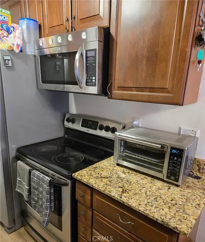 a kitchen with stainless steel appliances granite countertop a stove and a microwave