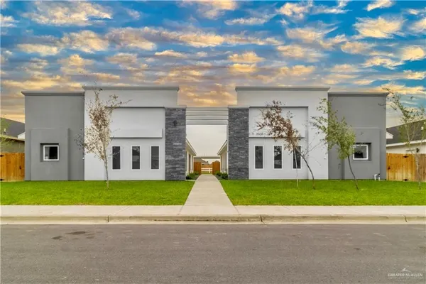 a view of a house with a yard and a garden