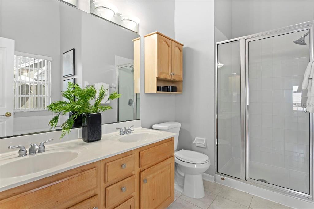 1450 Harbour Walk Road Tampa, FL 33602 - Photo 15 of 26 a bathroom with a granite countertop sink a toilet a mirror and shower