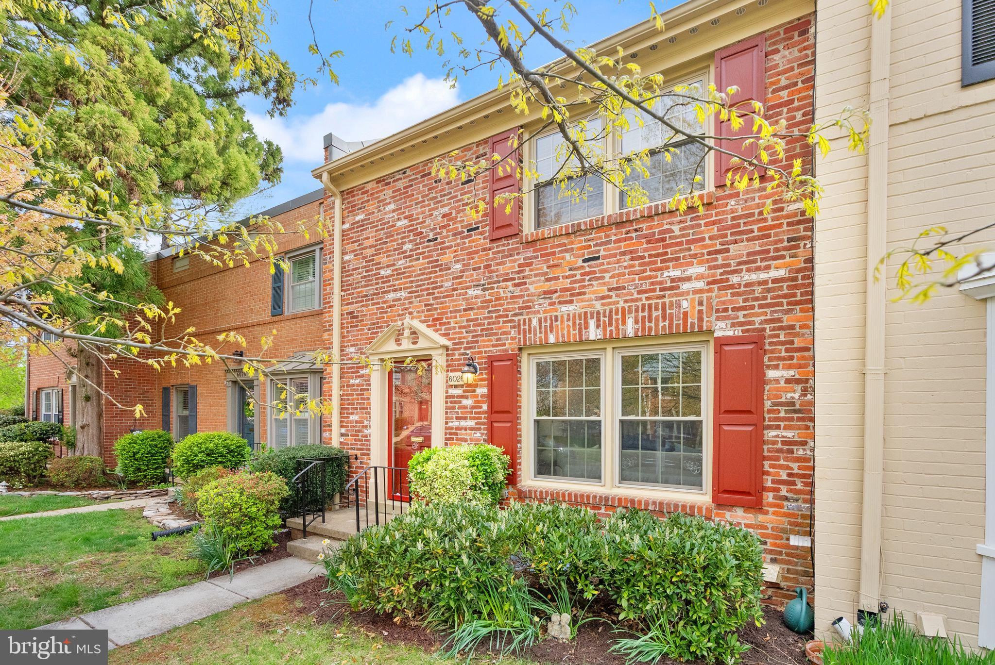 a view of a brick building next to a yard