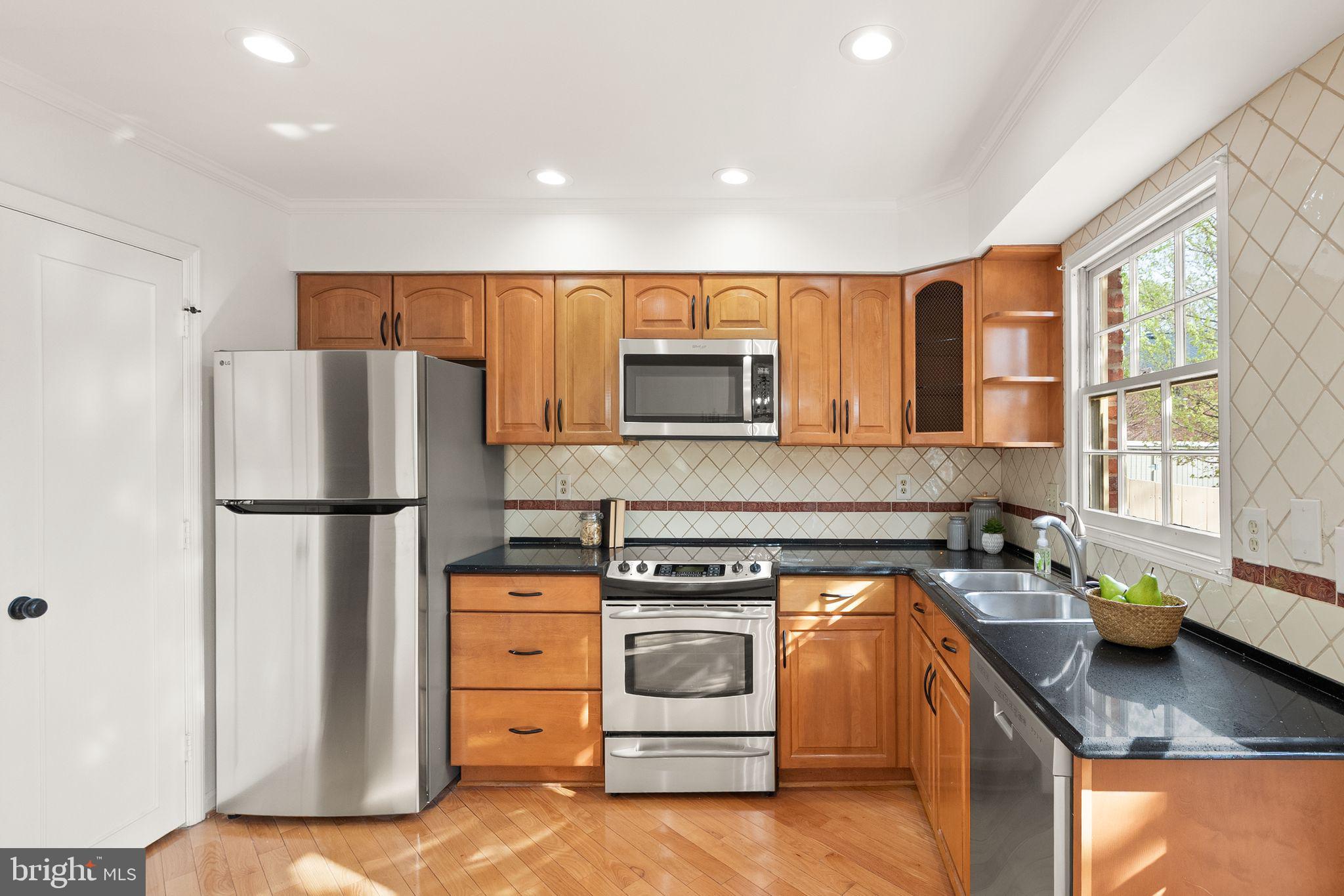 6026 Queenston Street Springfield, VA 22152 - Photo 13 of 53 a kitchen with a stove a refrigerator and a sink
