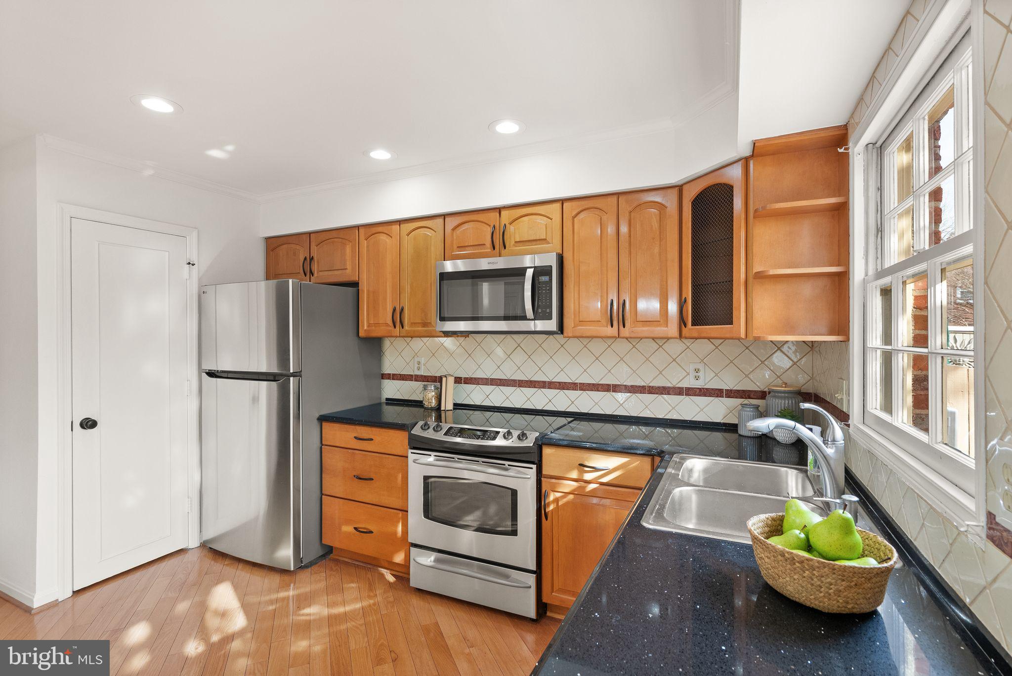 6026 Queenston Street Springfield, VA 22152 - Photo 14 of 53 a kitchen with sink and refrigerator