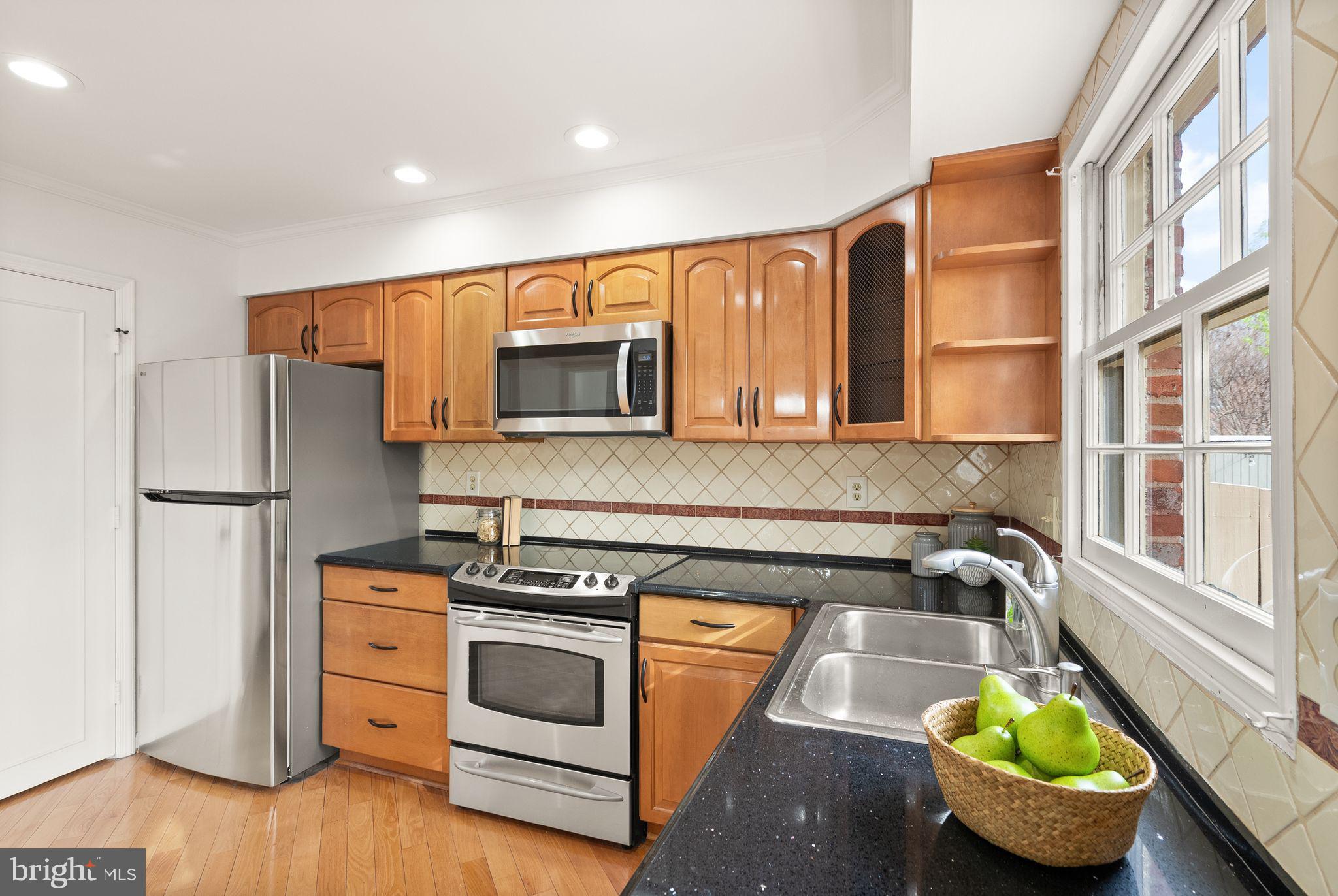 6026 Queenston Street Springfield, VA 22152 - Photo 15 of 53 a kitchen with stove and cabinets