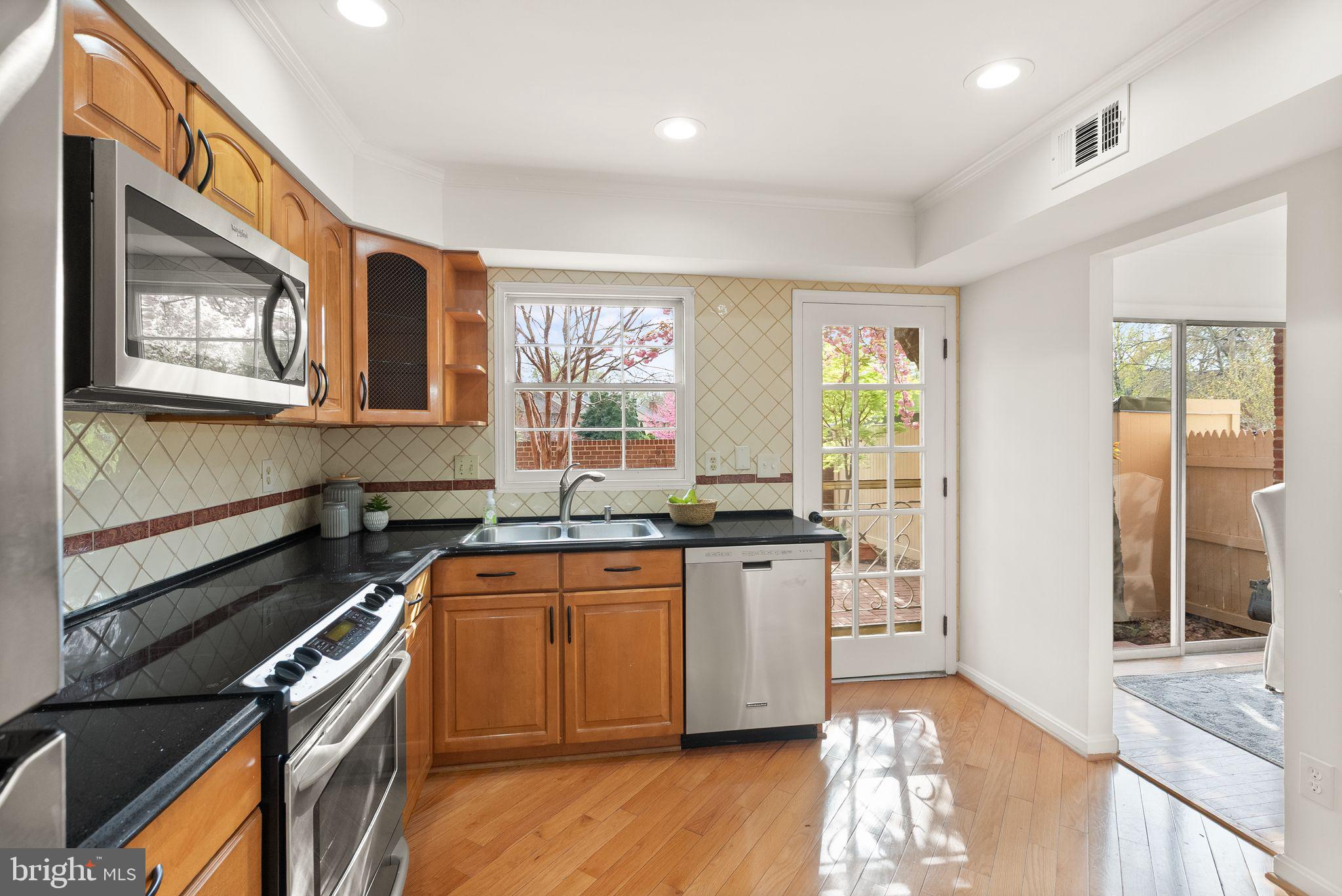 6026 Queenston Street Springfield, VA 22152 - Photo 16 of 53 a kitchen with stainless steel appliances granite countertop a stove a sink and a microwave