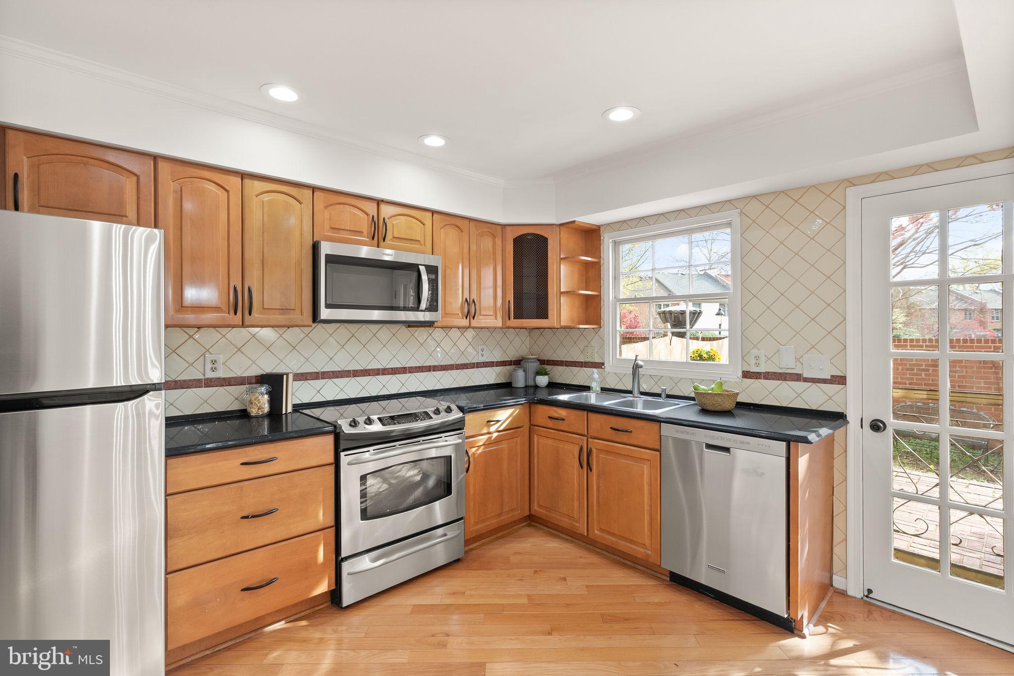 6026 Queenston Street Springfield, VA 22152 - Photo 17 of 53 a kitchen with granite countertop appliances cabinets and a sink