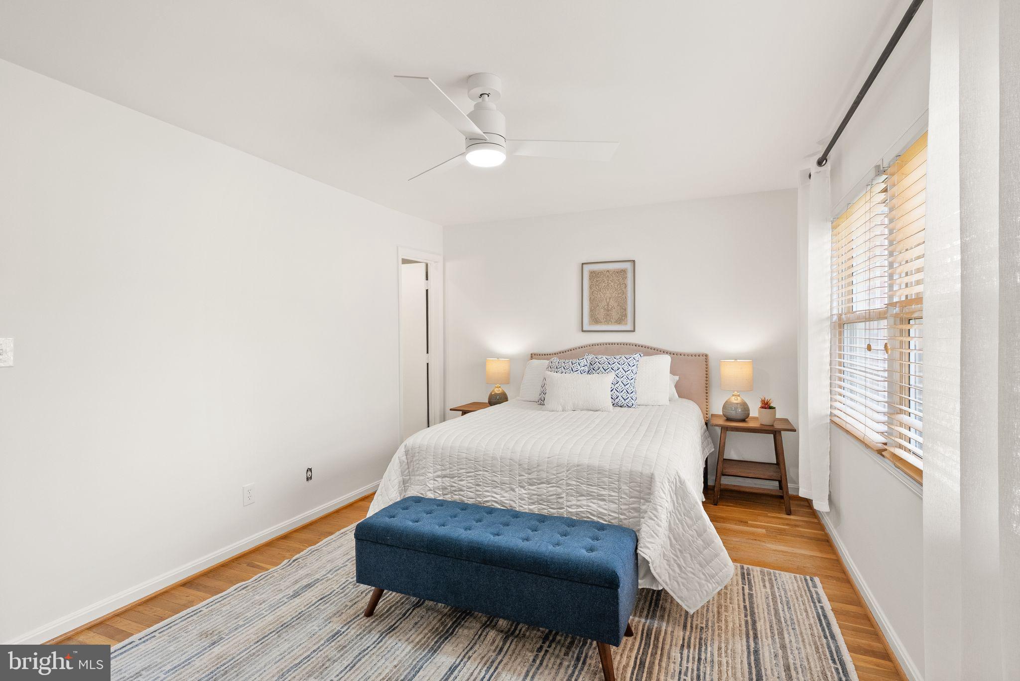 6026 Queenston Street Springfield, VA 22152 - Photo 23 of 53 a bedroom with a bed and wooden floor