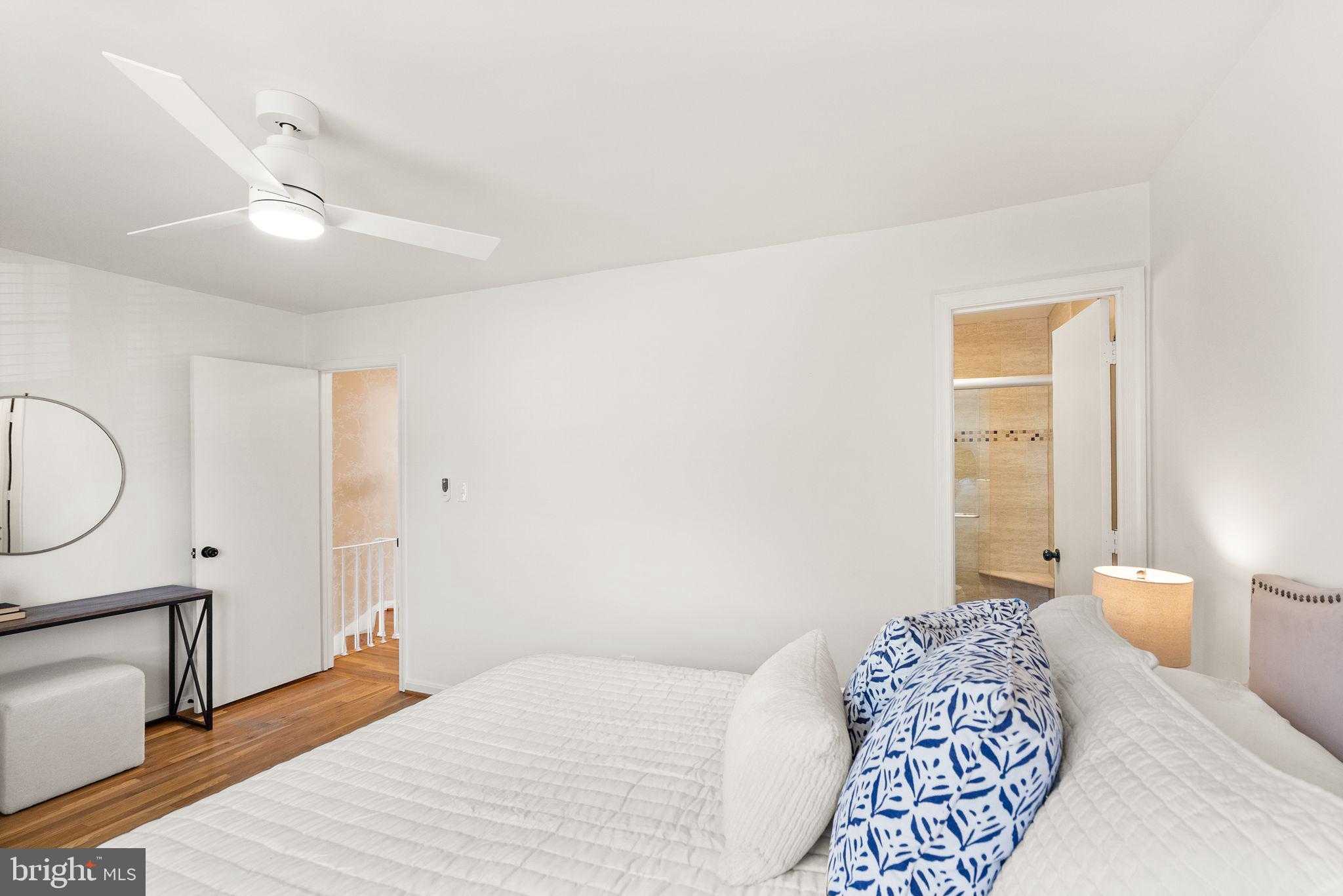 6026 Queenston Street Springfield, VA 22152 - Photo 24 of 53 a bedroom with a bed a chandelier and a window