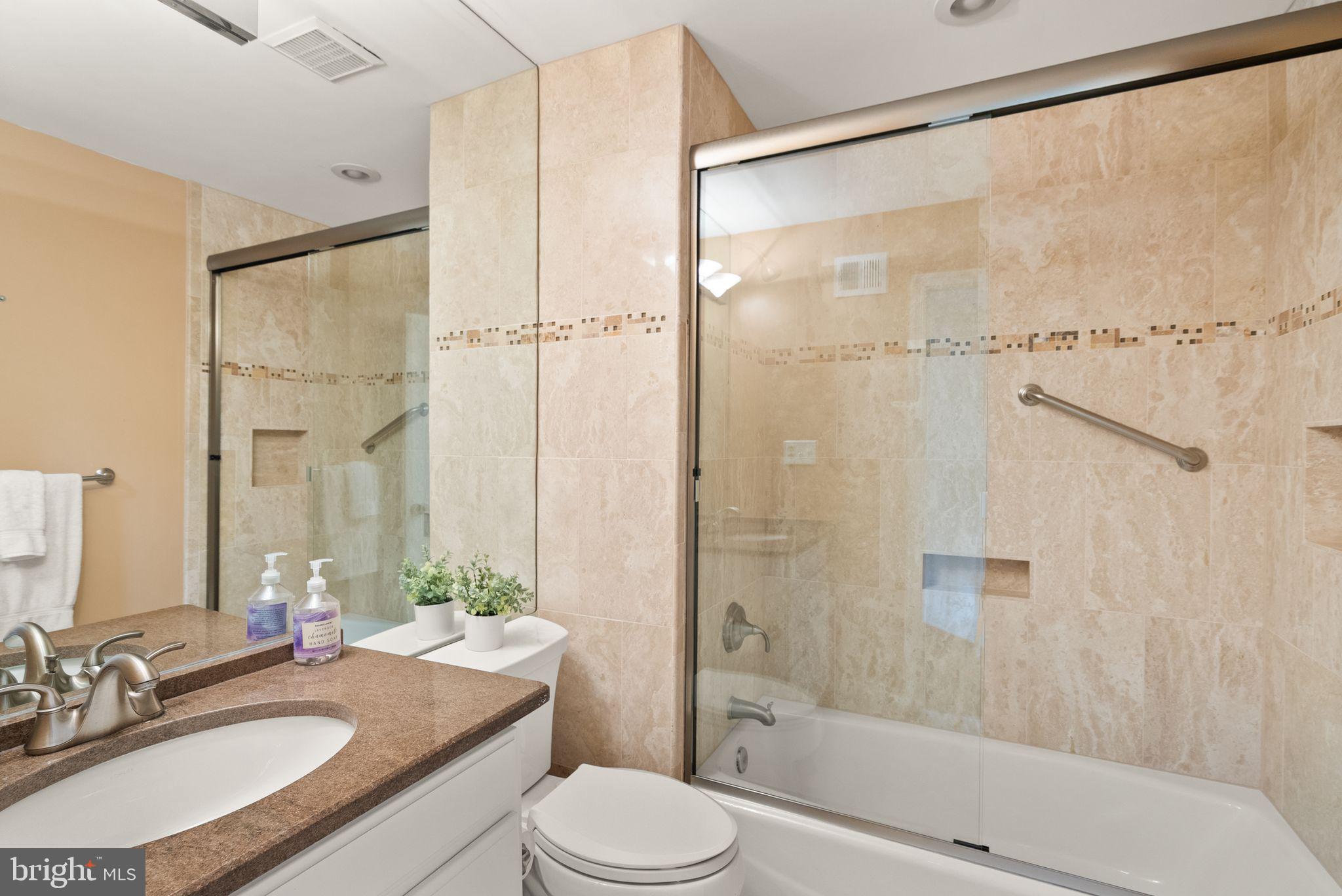 6026 Queenston Street Springfield, VA 22152 - Photo 36 of 53 a bathroom with a granite countertop sink toilet and shower