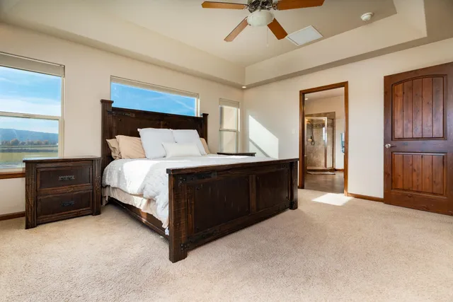 a bedroom with a bed and a chandelier