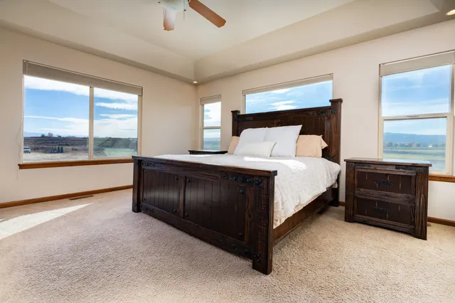 a bedroom with a bed and a large window