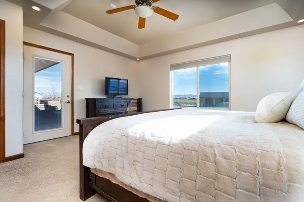 a large bedroom with a bed and a chandelier