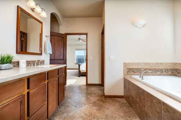 a spacious bathroom with a sink and a mirror