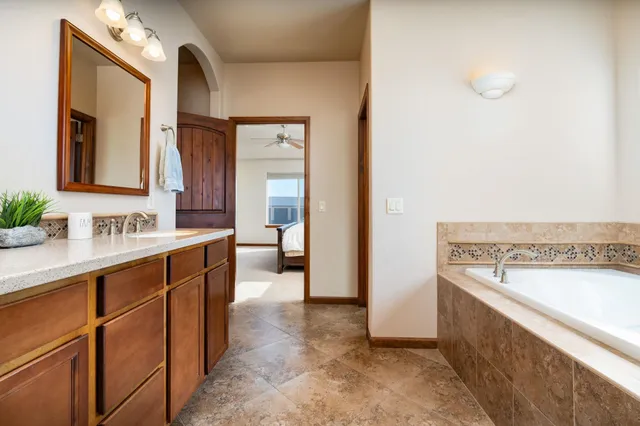 a spacious bathroom with a sink and a mirror