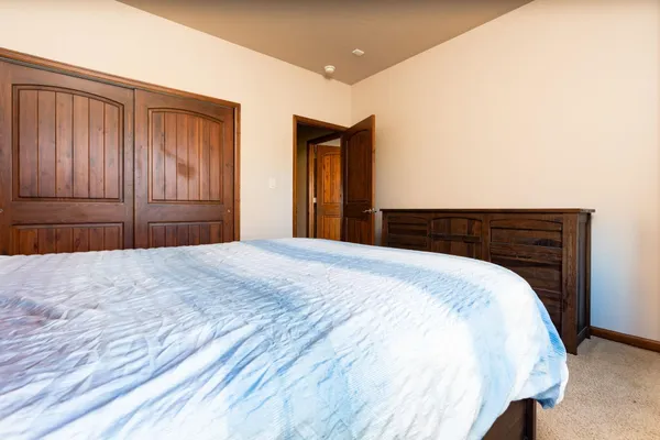 a bedroom with a bed and a dresser