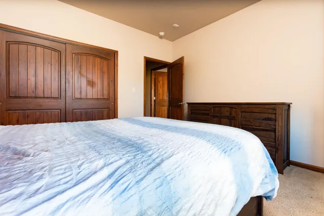 a bedroom with a bed and a dresser