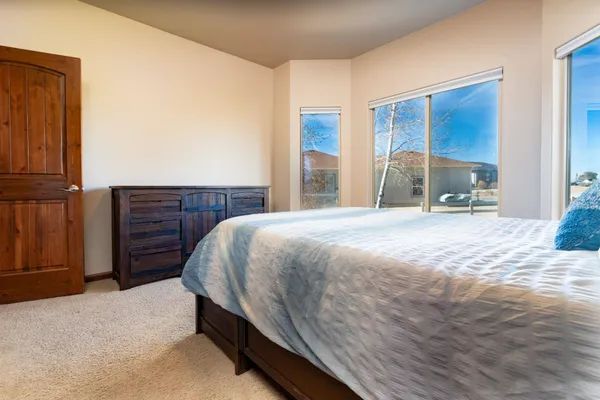 a spacious bedroom with a bed and a dresser