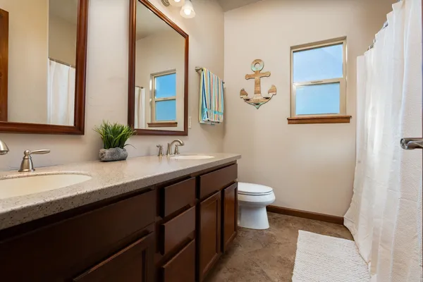 a bathroom with a double vanity sink and a mirror